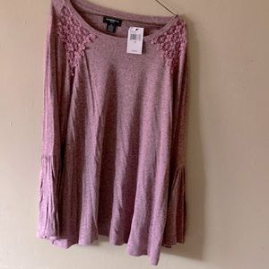 Pink sweater with black print.